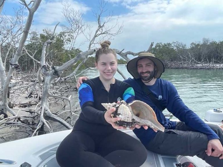 Two people are celebrating their shell discovery.