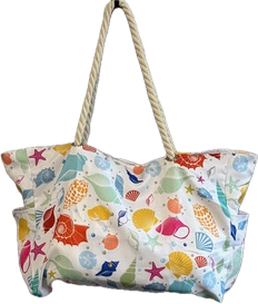 Colorful beach bag with seashell pattern and rope handles.