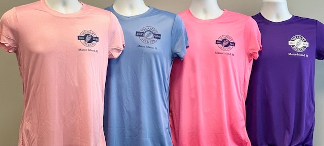 Four shirts in pink, blue, pink, and purple displayed on mannequins.
