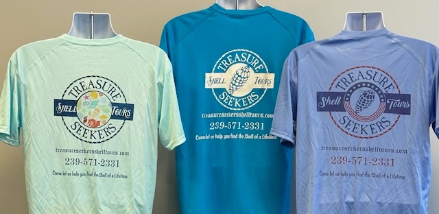 Three T-shirts on display with 'Treasure Seekers Shell Tours' logo and contact info.