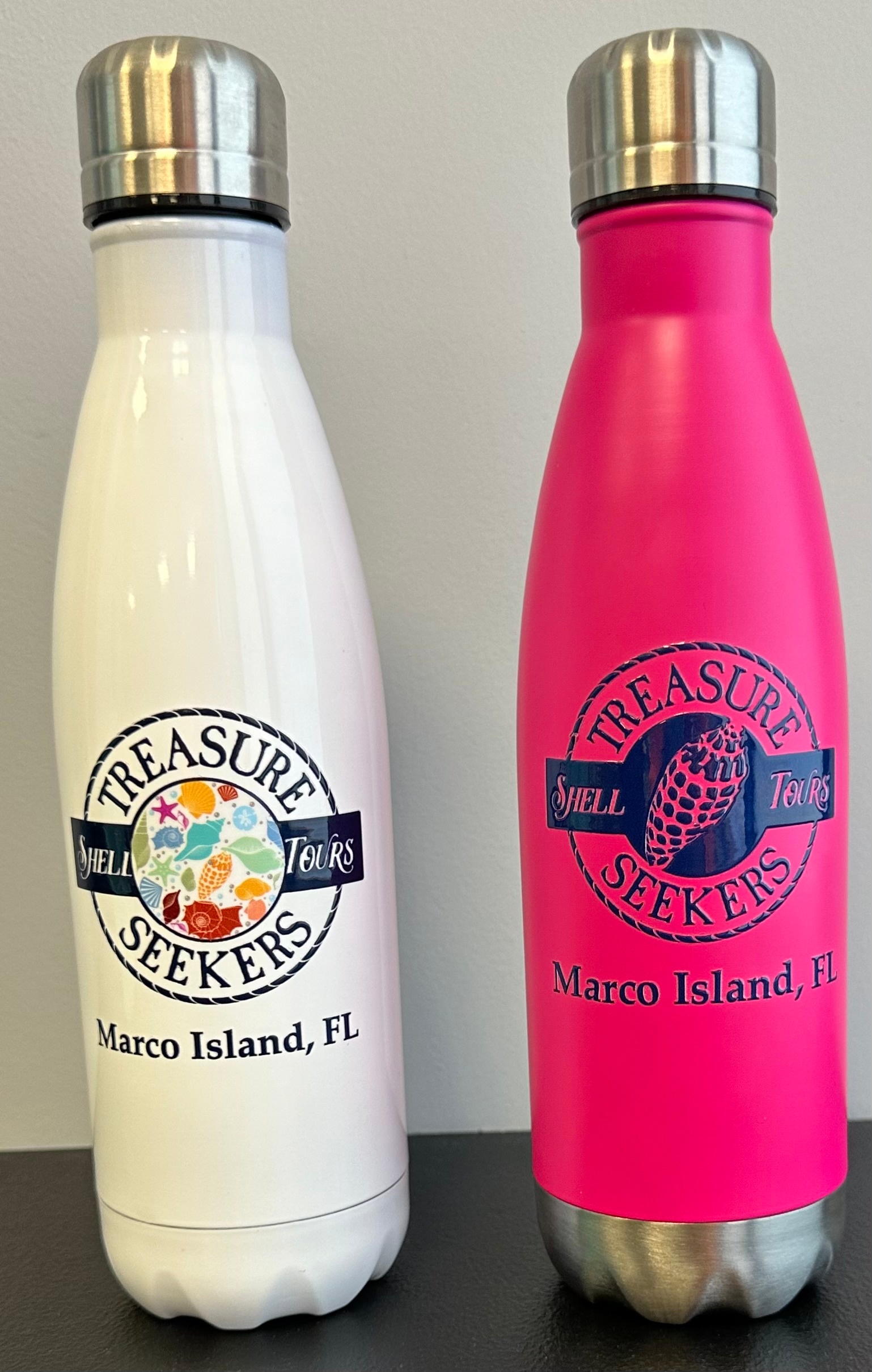 Two insulated bottles, one white and one pink, with 'Treasure Seekers' logo and 'Marco Island, FL' text.