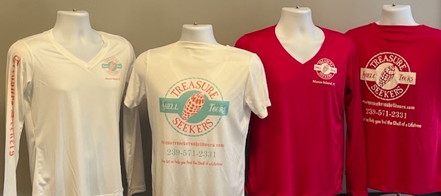 Four mannequins wearing Treasure Seekers branded V-neck shirts.