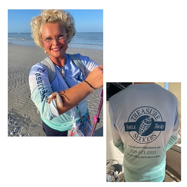Smiling person on beach with a starfish on arm, wearing 'Treasure Seekers' shirt.